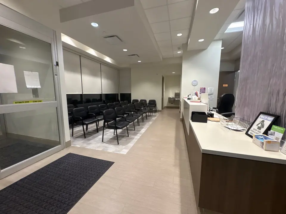 Professional day porter maintaining a clean hospital waiting area lobby in Huntsville, AL