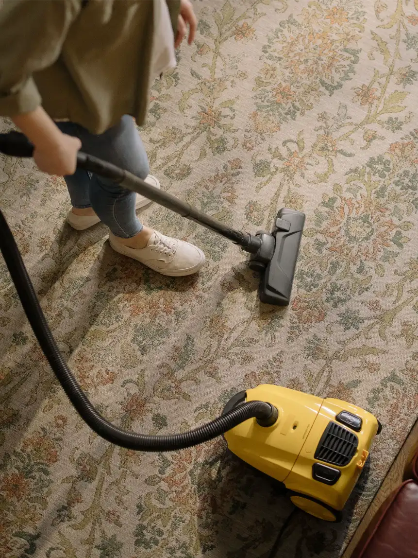 Professional carpet cleaner using a commercial extraction vacuum on office carpet in Huntsville, AL