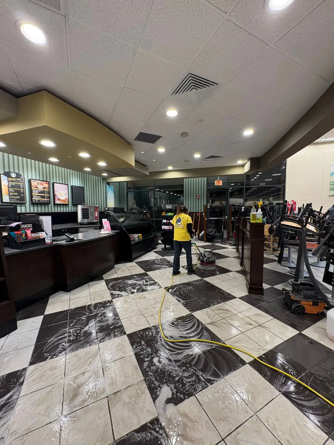 Commercial floor scrubber cleaning a restaurant floor in Huntsville, AL