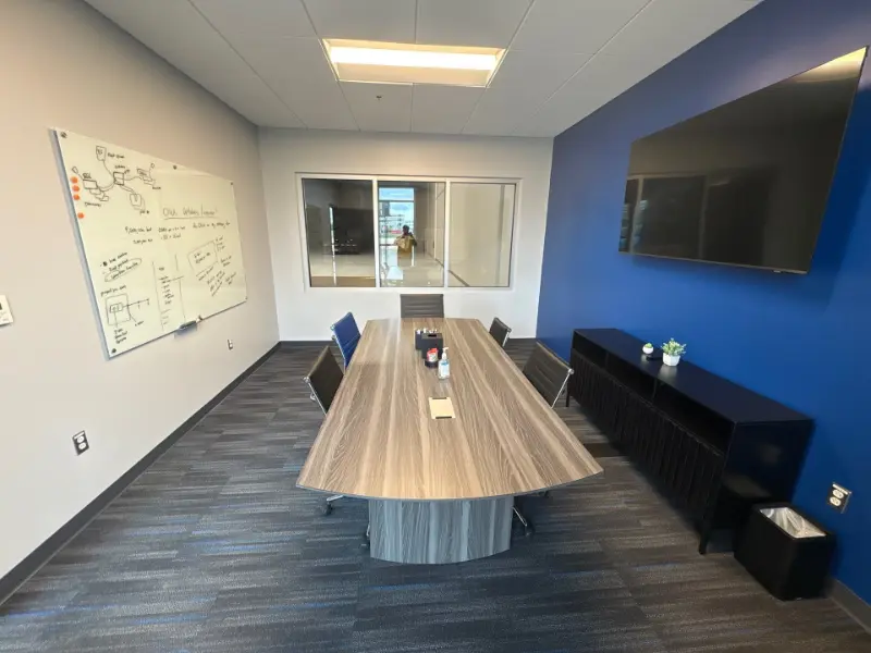 Day porter cleaning and sanitizing an office conference room in Huntsville, AL