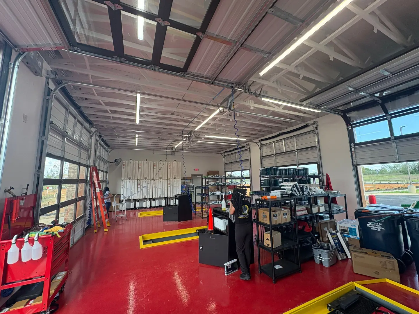 Professional day porter cleaning inside an oil change shop in Huntsville, AL