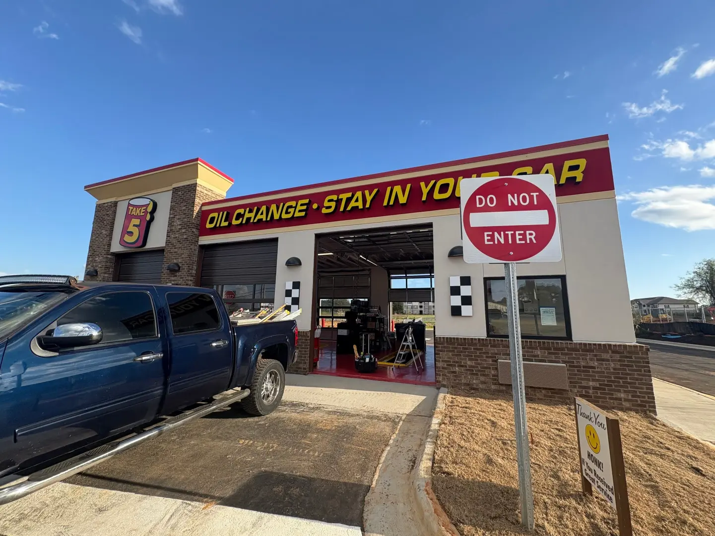 Daytime maintenance and cleaning of an oil change shop outside parking space in Huntsville, AL