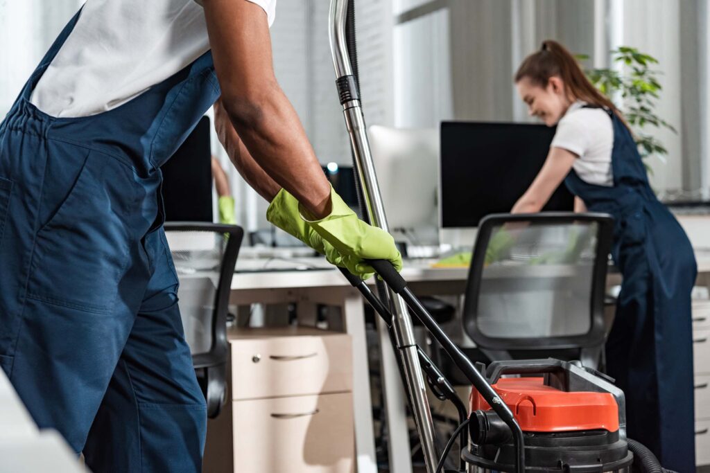 Professional cleaner vacuuming a downtown Birmingham, AL office